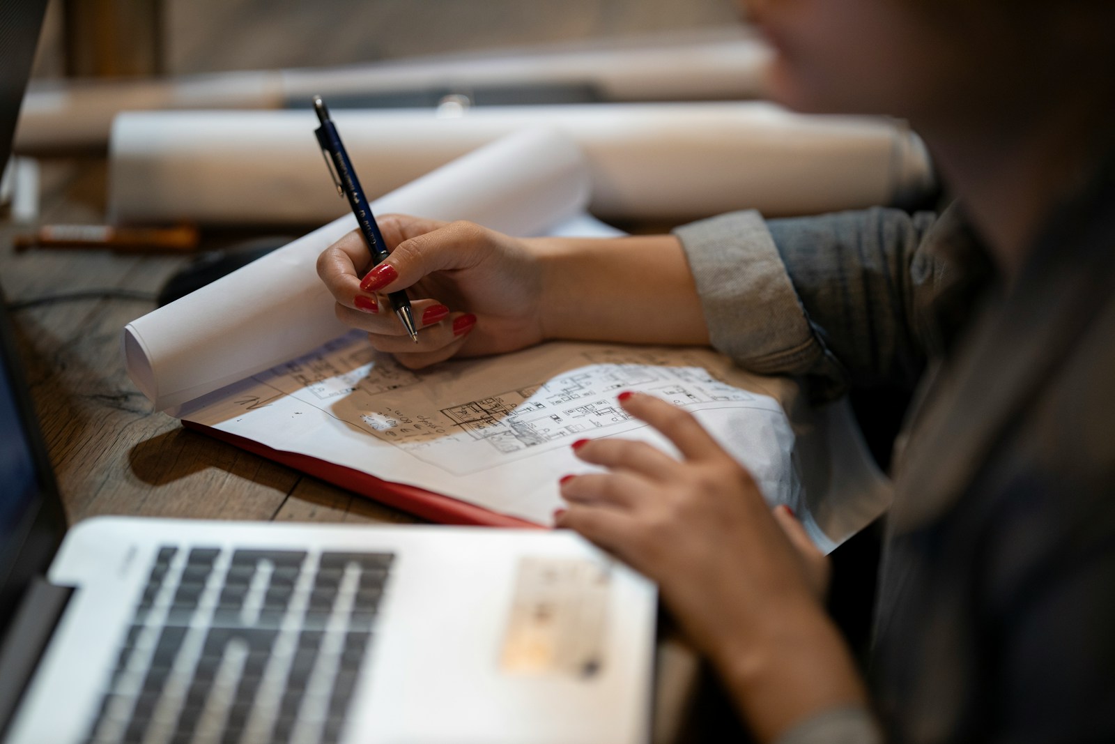 person in white shirt writing on white paper