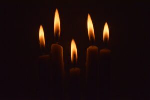 a group of lit candles in the dark