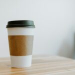white and brown paper cup
