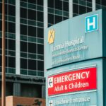 Victoria hospital emergency entrance sign with building